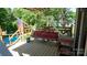 Relaxing deck area with a porch swing overlooking the pool and backyard at 12601 Guardhouse Ct, Charlotte, NC 28262