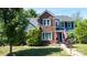Charming two-story home with a brick facade, dark shutters, blue siding and a well maintained lawn at 12601 Guardhouse Ct, Charlotte, NC 28262