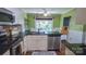 Functional kitchen with dark countertops, white cabinetry, and stainless steel appliances at 12601 Guardhouse Ct, Charlotte, NC 28262