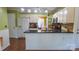 Well-lit kitchen featuring an eat-in island, stainless steel appliances, and dark countertops at 12601 Guardhouse Ct, Charlotte, NC 28262