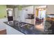 Bright eat-in kitchen featuring stainless steel appliances, dark countertops, and eat-in dining at 12601 Guardhouse Ct, Charlotte, NC 28262