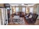 Comfortable living room featuring a fireplace, ceiling fan, and bright, natural light at 12601 Guardhouse Ct, Charlotte, NC 28262