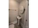 Half bathroom features a modern sink, toilet, and oval mirror at 1415 S York Rd, Gastonia, NC 28052