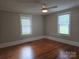 Bright bedroom features hardwood floors and natural light from two windows at 1415 S York Rd, Gastonia, NC 28052