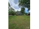 Quaint single story home from a distance surrounded by a spacious front lawn and mature shade trees at 1415 S York Rd, Gastonia, NC 28052