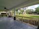 View from the covered front porch showcasing the wood railings, stained decking, and the surrounding lawn at 1415 S York Rd, Gastonia, NC 28052