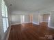 Bright living room with hardwood flooring, crown molding, large window with shutters and neutral wall paint at 1415 S York Rd, Gastonia, NC 28052