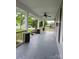 Spacious covered porch with wood railing and ceiling fan for outdoor enjoyment at 1415 S York Rd, Gastonia, NC 28052