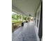 Long, covered porch with wood railing and ceiling fan offers curb appeal at 1415 S York Rd, Gastonia, NC 28052