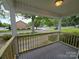 Covered front porch with wood railing offers a relaxing outdoor space at 1415 S York Rd, Gastonia, NC 28052