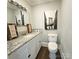 Well-lit bathroom with granite countertop and bridge art at 169 Freeze Nw Ave, Concord, NC 28025