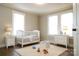 Bright Bedroom with a white crib, dresser, and two windows, creating a serene and inviting space at 169 Freeze Nw Ave, Concord, NC 28025
