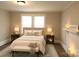 This bedroom features a comfortable bed, two windows, and a cozy fireplace with decorative candles at 169 Freeze Nw Ave, Concord, NC 28025