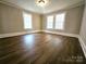 Bright, airy bedroom featuring hardwood floors and white trim details at 169 Freeze Nw Ave, Concord, NC 28025
