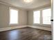 Bright bedroom featuring hardwood floors, neutral wall colors, and white trim details at 169 Freeze Nw Ave, Concord, NC 28025