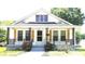 Charming home featuring a quaint porch, decorative railings, and lovely wooden shutters at 169 Freeze Nw Ave, Concord, NC 28025