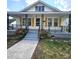 Charming home featuring a welcoming porch with decorative railings and beautifully landscaped front yard at 169 Freeze Nw Ave, Concord, NC 28025