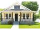 Charming home with a cozy front porch featuring rocking chairs and decorative iron railings at 169 Freeze Nw Ave, Concord, NC 28025