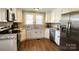 Modern kitchen with stainless steel appliances, granite countertops, and white cabinets at 169 Freeze Nw Ave, Concord, NC 28025