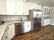Modern kitchen featuring stainless steel appliances, white cabinetry, and granite countertops at 169 Freeze Nw Ave, Concord, NC 28025