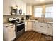 Modern kitchen with stainless steel appliances, granite countertops, and new white cabinets at 169 Freeze Nw Ave, Concord, NC 28025