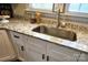 Modern kitchen sink, granite countertops and white cabinetry create a clean, updated space at 169 Freeze Nw Ave, Concord, NC 28025