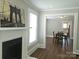 Inviting living room showcasing a fireplace, connecting to a dining area with wood floors at 169 Freeze Nw Ave, Concord, NC 28025