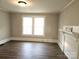 Cozy living room featuring hardwood floors, a decorative fireplace, and natural light at 169 Freeze Nw Ave, Concord, NC 28025