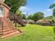 Lush backyard featuring a brick staircase and plenty of green space at 170 8Th Ave, Cramerton, NC 28032
