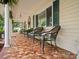 Inviting porch showcases mosaic tile flooring and plenty of seating to enjoy outdoor comfort at 170 8Th Ave, Cramerton, NC 28032