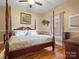 Warm main bedroom with wood floors, four poster bed, and neutral walls at 170 8Th Ave, Cramerton, NC 28032