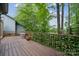 Spacious backyard deck, surrounded by lush trees, featuring an ivy-covered privacy screen, a spa, and railing at 18 Shipmaster Ct, Clover, SC 29710