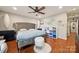 Primary bedroom with a large upholstered headboard, hardwood flooring, and natural light at 18 Shipmaster Ct, Clover, SC 29710