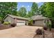Ranch-style home with a two car garage, mature trees, and an American flag waving at 18 Shipmaster Ct, Clover, SC 29710