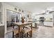 Open kitchen with white cabinets, stainless appliances, and eat-in area with slider to patio at 18 Shipmaster Ct, Clover, SC 29710