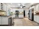 Well-lit kitchen featuring white cabinets, stainless steel appliances, and tile flooring at 18 Shipmaster Ct, Clover, SC 29710
