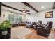 Inviting living room featuring a large sectional, ceiling fan, and beautiful hardwood floors at 18 Shipmaster Ct, Clover, SC 29710