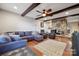 Spacious living room with beamed ceilings, stone fireplace, comfortable seating, and hardwood floors at 18 Shipmaster Ct, Clover, SC 29710