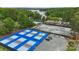 Aerial view featuring vibrant pickleball and tennis courts nestled in a scenic, wooded setting at 18 Shipmaster Ct, Clover, SC 29710