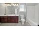 A well-lit bathroom with double sink vanity, tile flooring and tub at 1855 Second Baxter Xing, Fort Mill, SC 29708