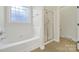 Bright bathroom includes tile floor, a shower, tub, and frosted glass window at 1855 Second Baxter Xing, Fort Mill, SC 29708