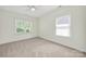 A bedroom with light walls and carpet flooring. Two windows offer natural light at 1855 Second Baxter Xing, Fort Mill, SC 29708
