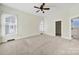 This bedroom includes carpeted floor, ceiling fan, natural light, and is ready for move-in at 1855 Second Baxter Xing, Fort Mill, SC 29708