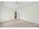 Neutral-colored bedroom with open closet, carpet flooring, and fan and light fixture at 1855 Second Baxter Xing, Fort Mill, SC 29708