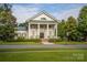 Traditional clubhouse with columns, front porch, and manicured lawn at 1855 Second Baxter Xing, Fort Mill, SC 29708