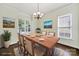 Formal dining room features natural light, decorative chandelier, and gorgeous wood flooring at 1855 Second Baxter Xing, Fort Mill, SC 29708