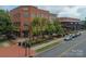 Brick commercial building exterior featuring outdoor seating, lush greenery, and well-maintained sidewalks at 1855 Second Baxter Xing, Fort Mill, SC 29708