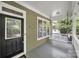 Inviting front porch with classic columns and a cozy porch swing at 1855 Second Baxter Xing, Fort Mill, SC 29708