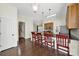 Open kitchen with stainless appliances, granite countertops, and breakfast bar, leads to staircase at 1855 Second Baxter Xing, Fort Mill, SC 29708