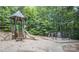 Well maintained playground with slides, ladders, and climbing features set in a wooded area at 1855 Second Baxter Xing, Fort Mill, SC 29708